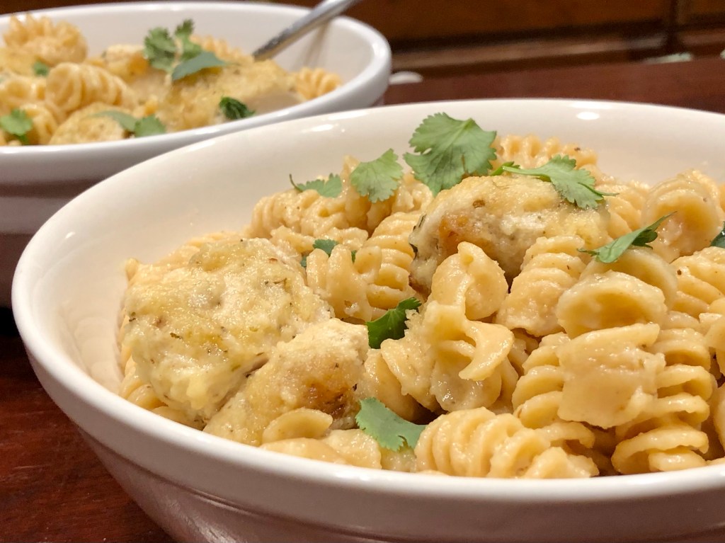 Two bowls of Chicken Rotini Alfredo, topped with parsley   