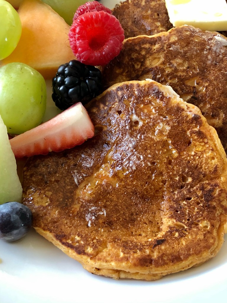 Sweet Potato Pancakes served with cut fruit